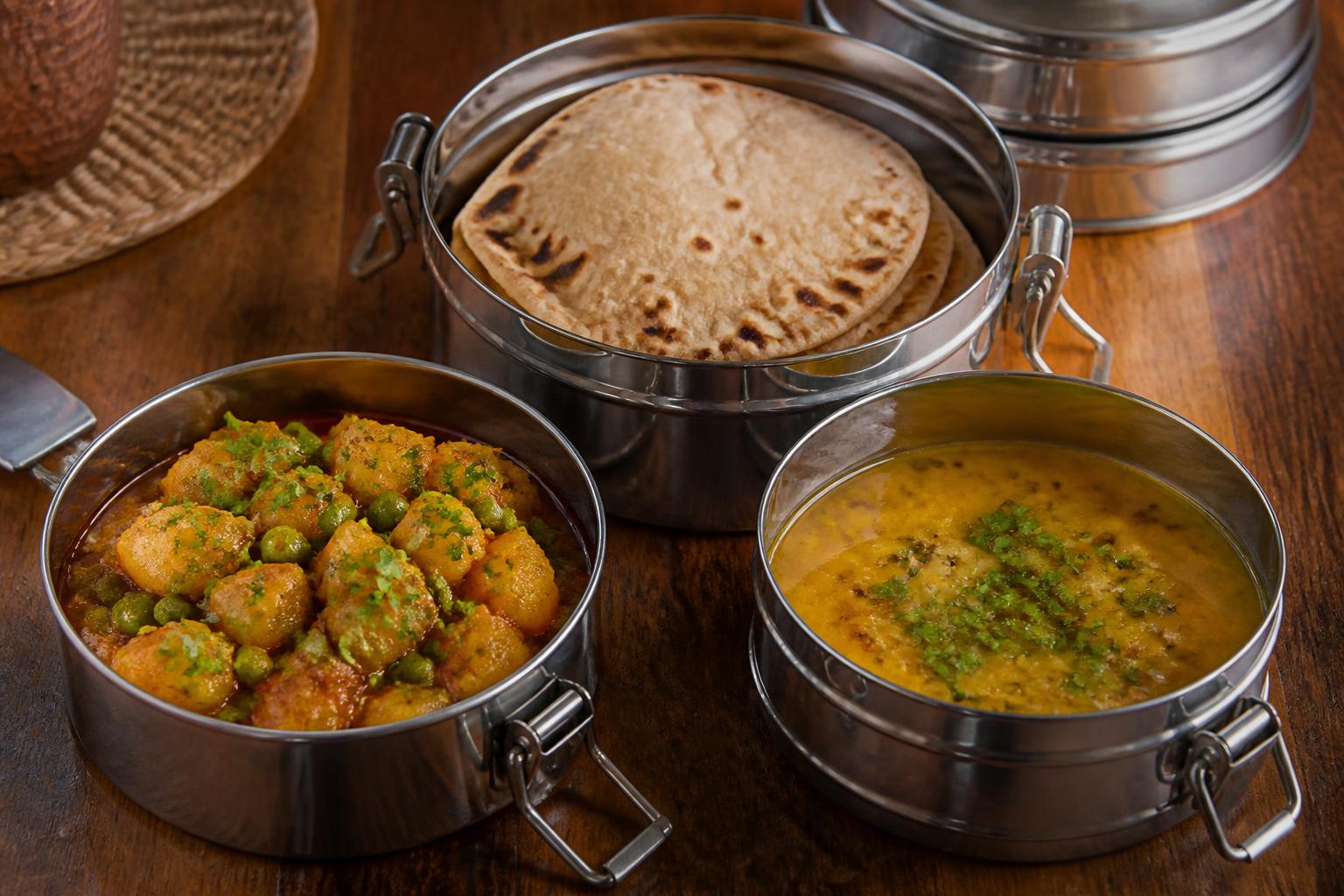 Steel tiffin containers packed with sabji, daal and fresh fulke